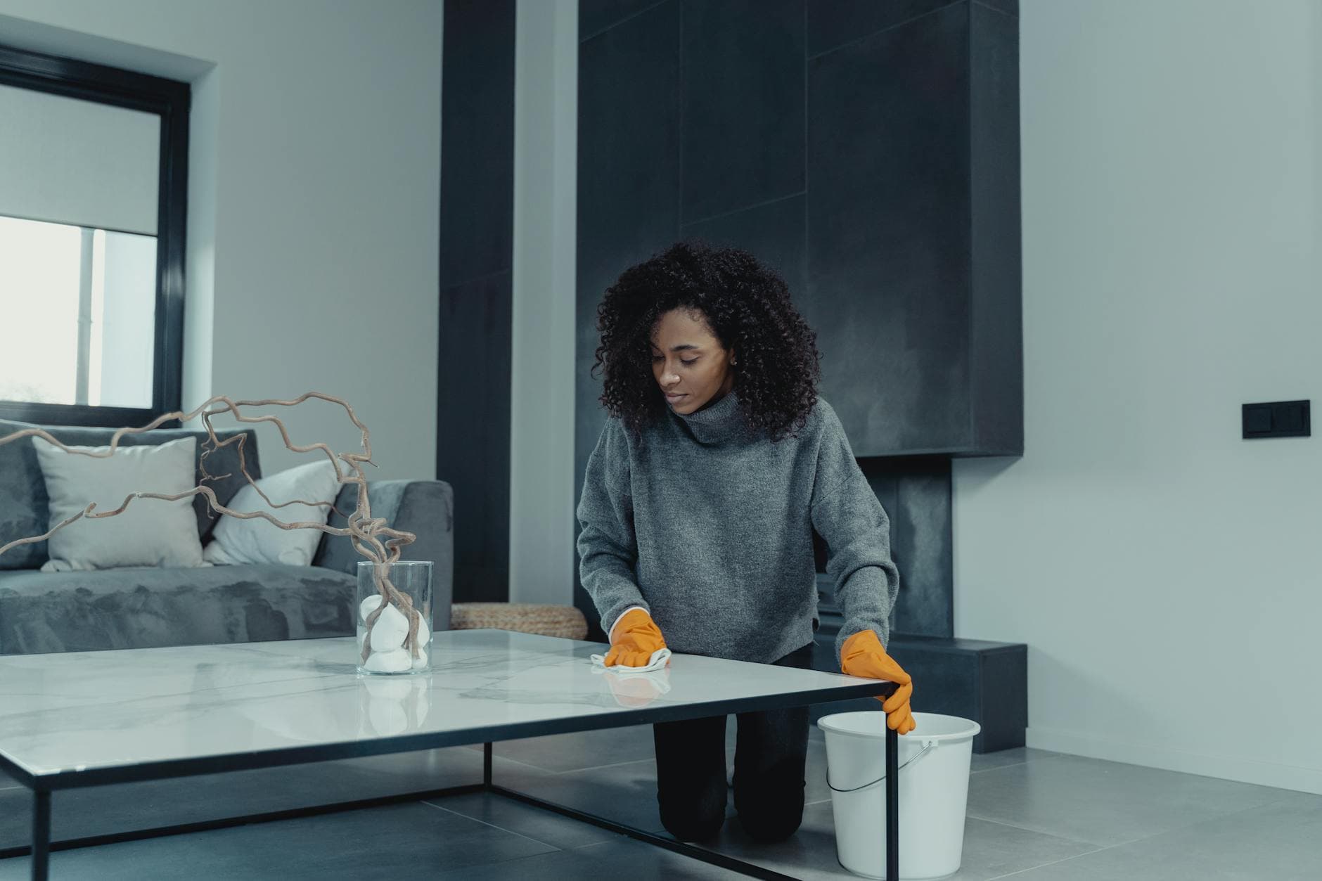 Professional house cleaner wiping a table in a contemporary New York apartment — Bi-Weekly Cleaning in Rye, Westchester County