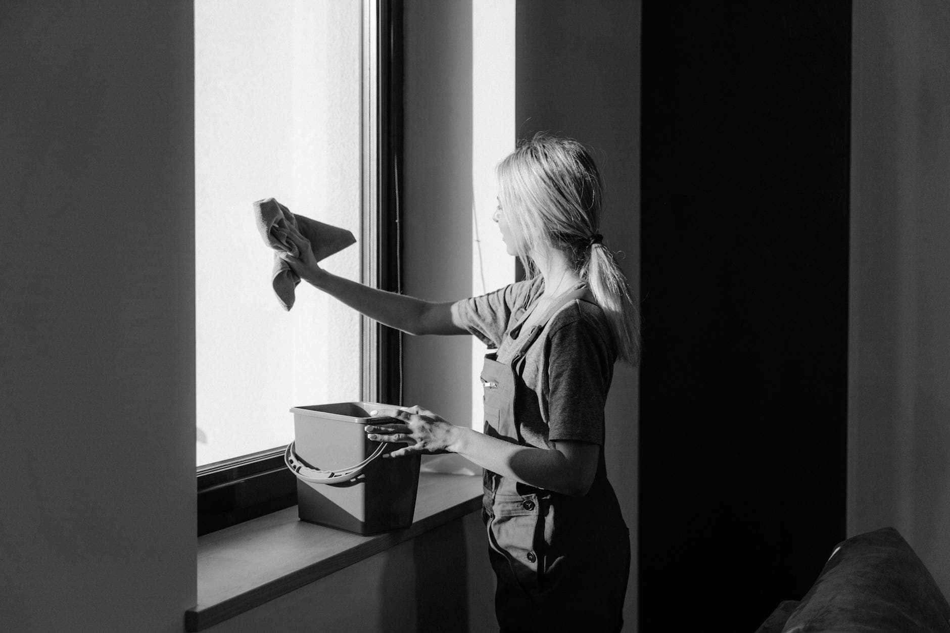 Professional window cleaning in a Westchester apartment using cloth and bucket — How to Clean High-Rise Apartment Windows in Westchester and the Hudson Valley (Safely)